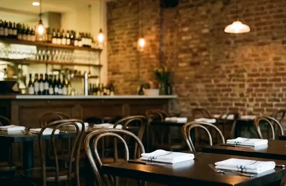 Gumba's dining room: exposed brick, bentwood chairs and warm pendant lights